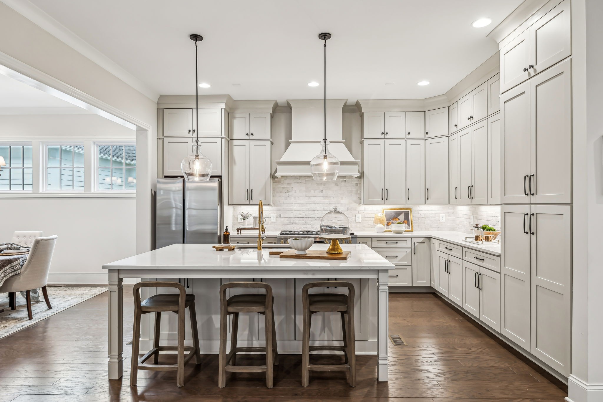 1221 Luckett Road Nashville, TN 37221 - Photo 15 of 59 a kitchen with stainless steel appliances granite countertop a table chairs stove and white cabinets