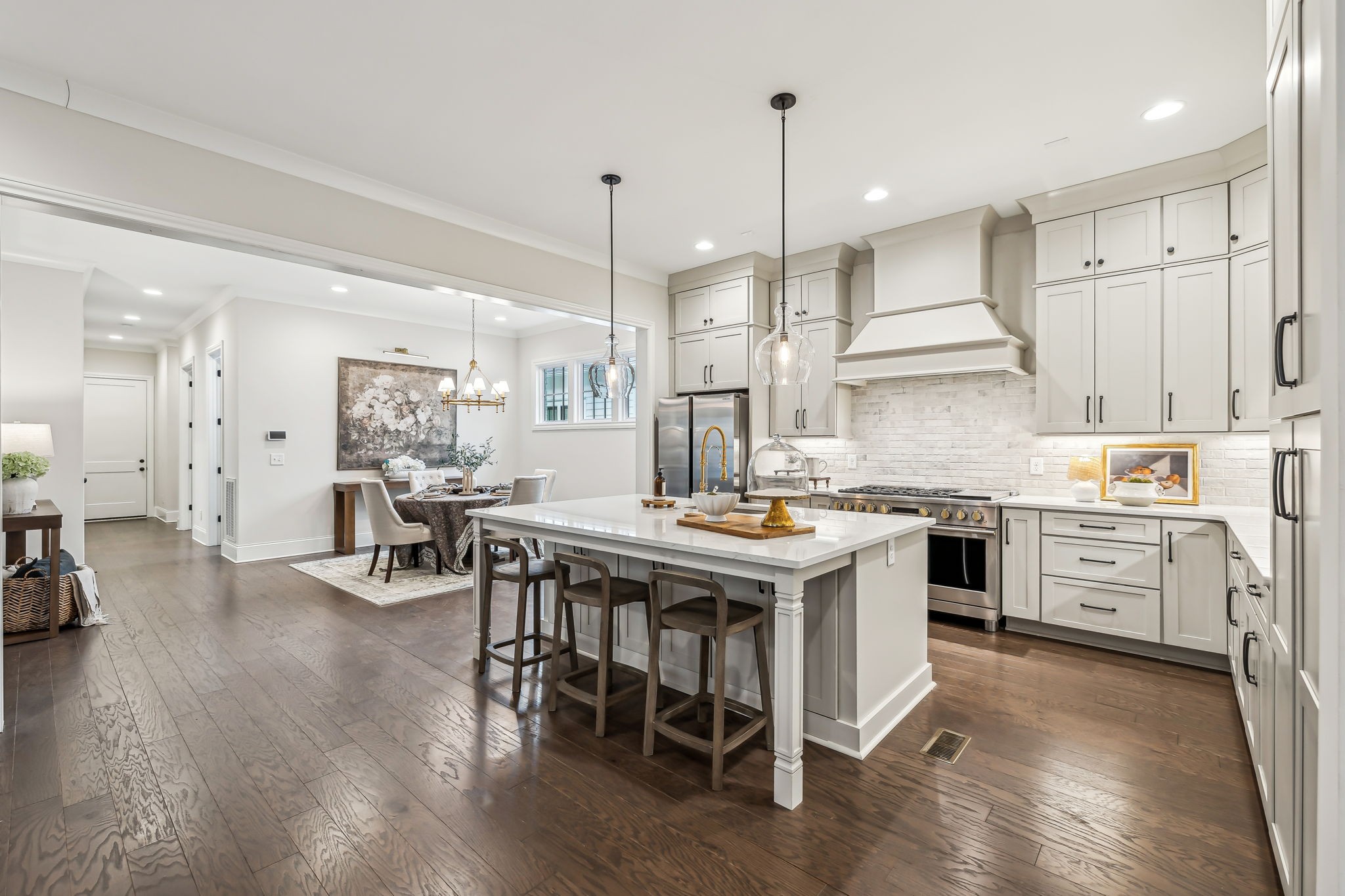 1221 Luckett Road Nashville, TN 37221 - Photo 18 of 59 a kitchen with a table chairs stove a sink dishwasher and a dining table with wooden floor