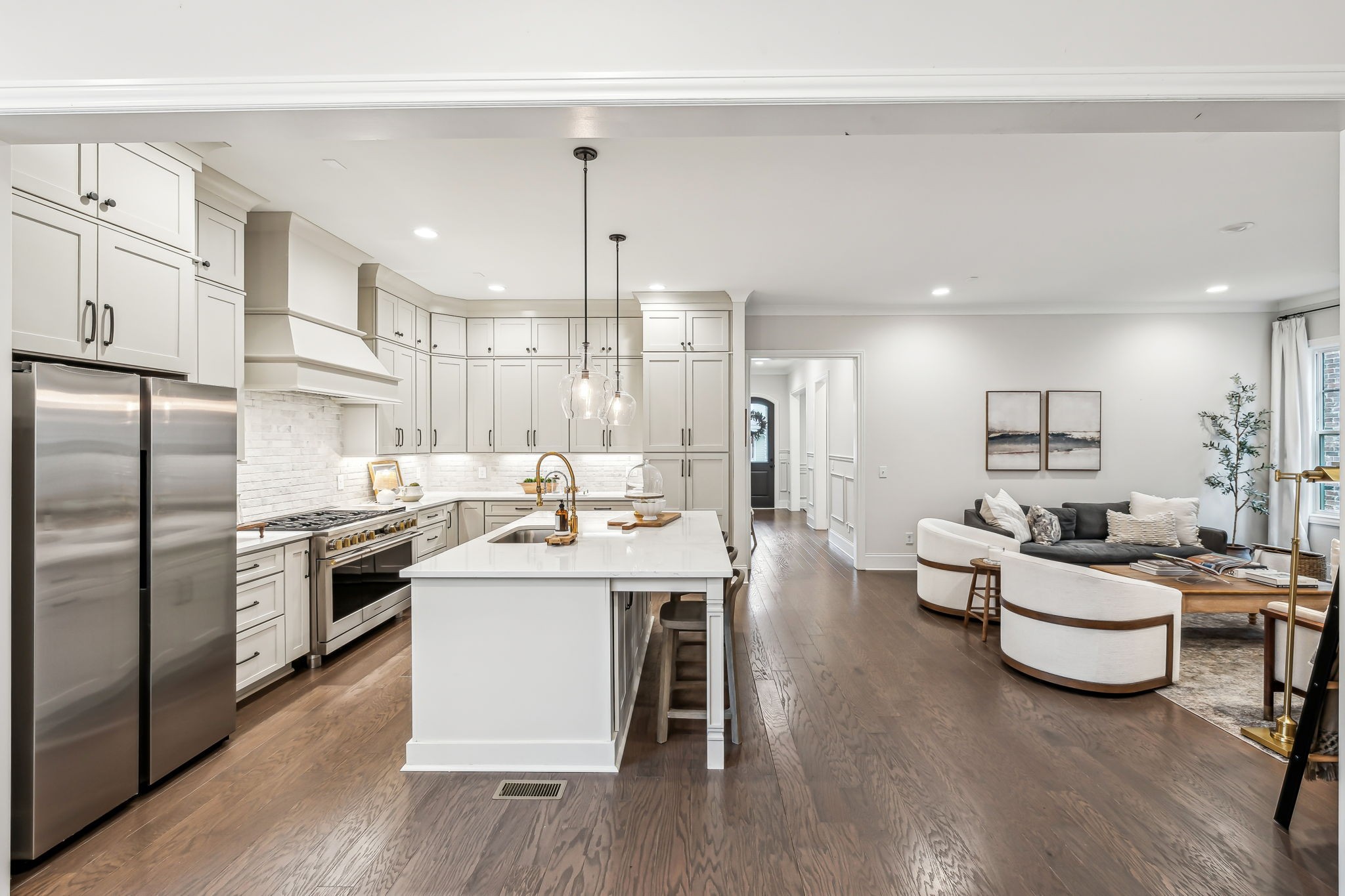 1221 Luckett Road Nashville, TN 37221 - Photo 22 of 59 a open kitchen with stainless steel appliances kitchen island granite countertop a stove a sink a refrigerator and white cabinets with wooden floor