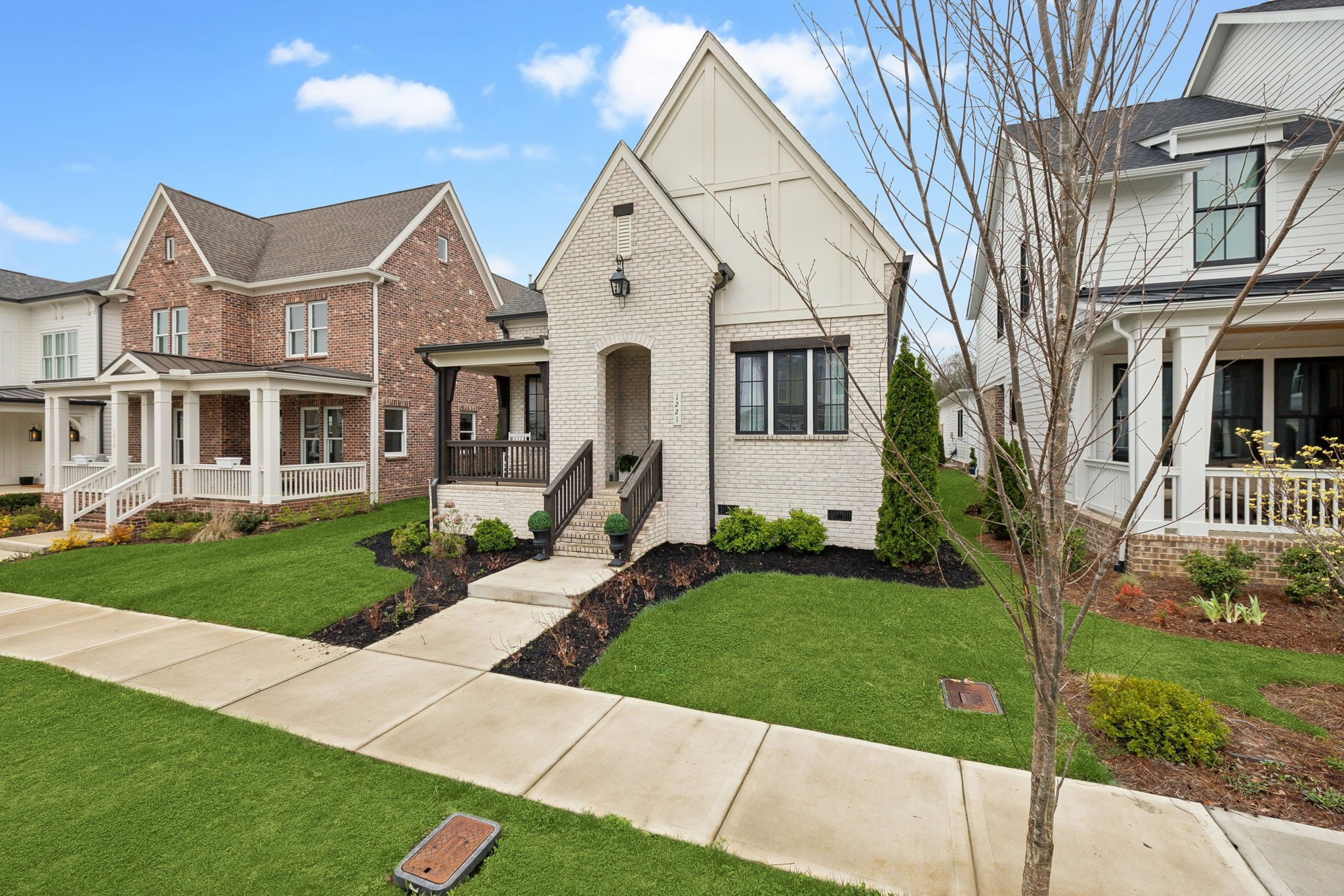 1221 Luckett Road Nashville, TN 37221 - Photo 3 of 59 a front view of a house with a yard and garage