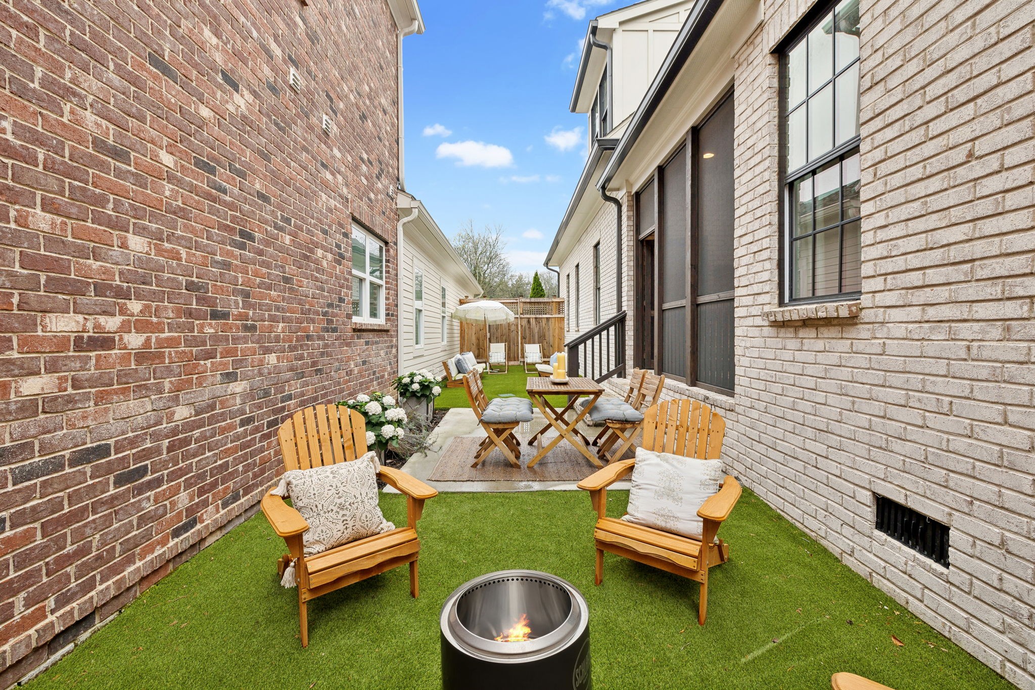 1221 Luckett Road Nashville, TN 37221 - Photo 47 of 59 a patio with patio couches and a fireplace with wooden floor