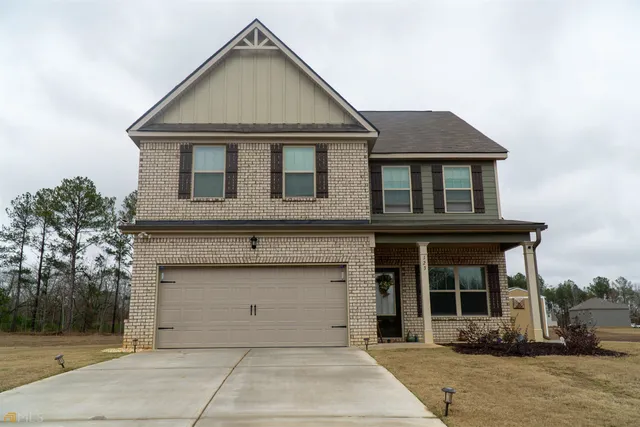 a front view of a house with garage