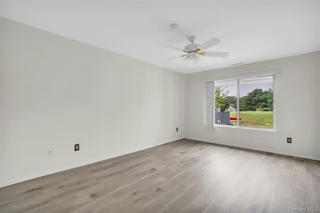 a front view of a house with yard and green space