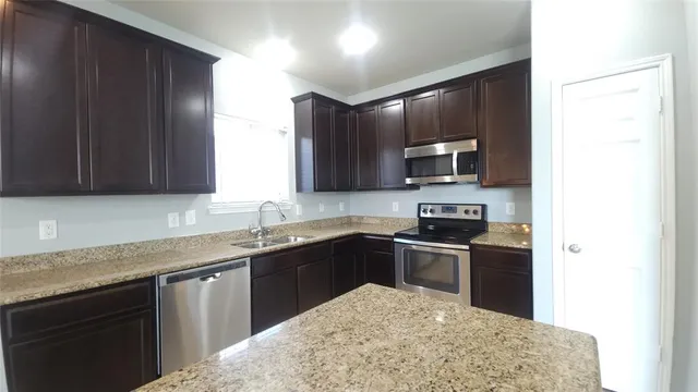 a kitchen with a sink and a window