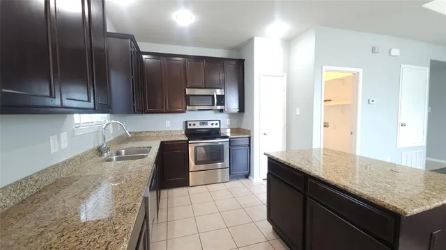 a kitchen with a sink stove and cabinets