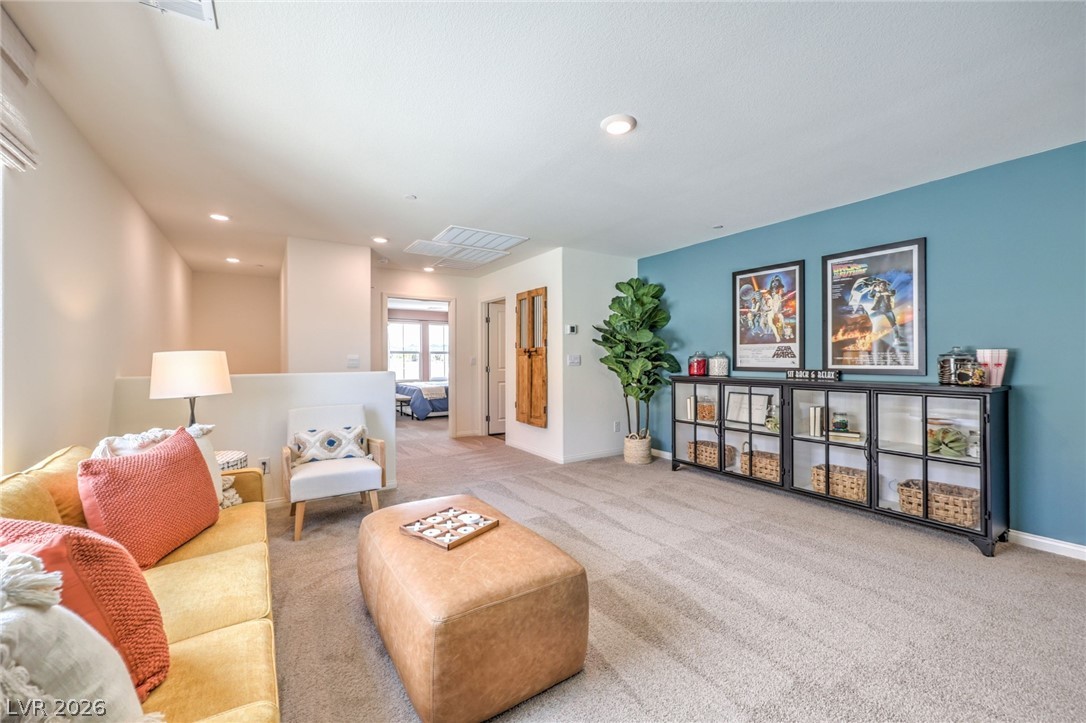 1017 Copper Robin Street Henderson, NV 89011 - Photo 27 of 43 Carpeted living area with recessed lighting and baseboards. Photo is representational only; actual home finishes may vary.