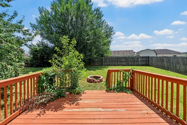 a view of a wooden deck with a yard