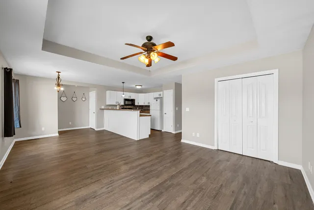 a view of a kitchen with a sink and a refrigerator