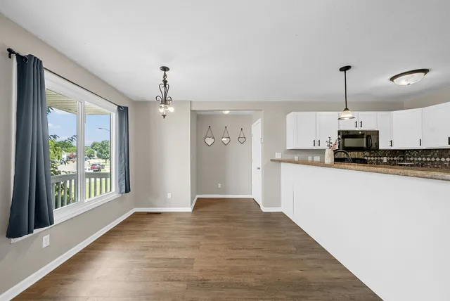 a view of a kitchen with a stove cabinets and wooden floor