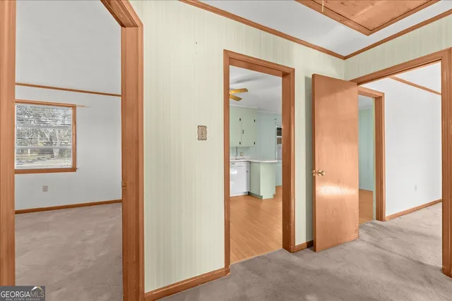 a kitchen with a sink cabinets and wooden floor
