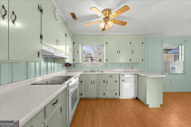 a view of a room with wooden floor and entryway