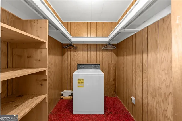 an empty room with windows and chandelier fan