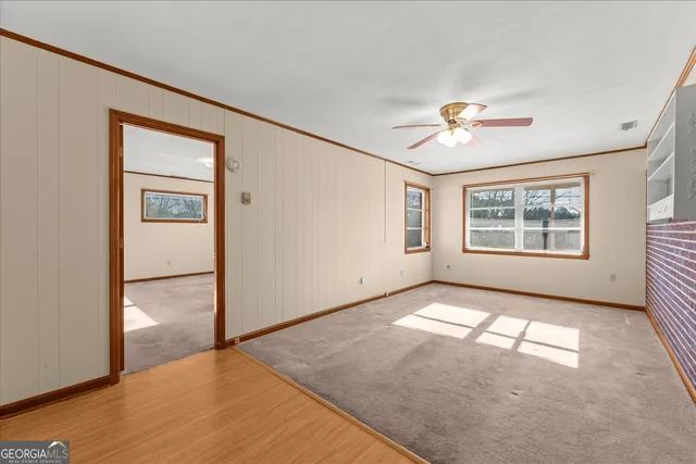 a view of a hallway with wooden floor and closet