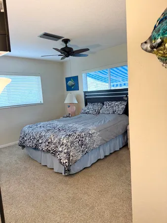 a bed sitting in a room next to a lamp