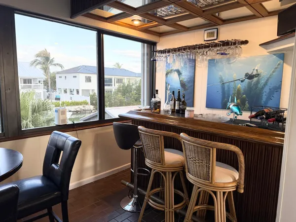 a kitchen with granite countertop white cabinets and black appliances