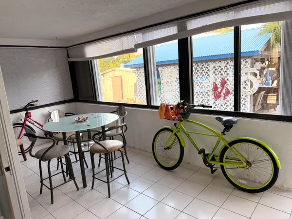 a view of a dining room with furniture large windows and wooden floor
