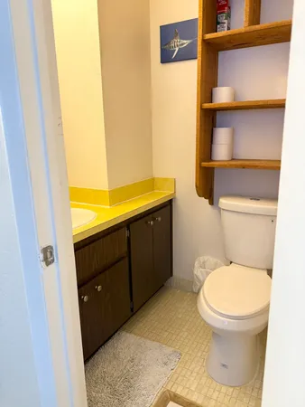 a view of a hallway with wooden floor and a utility room