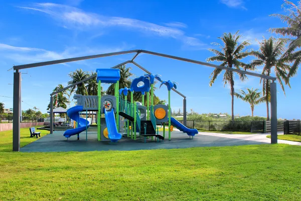 a view of a park with swings and slides