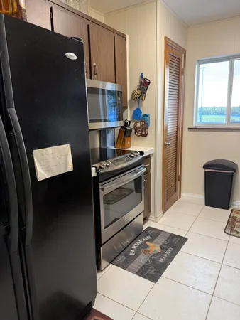 a kitchen with stainless steel appliances granite countertop a refrigerator and a stove