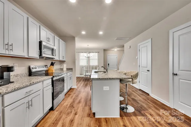 a kitchen with cabinets a sink and appliances