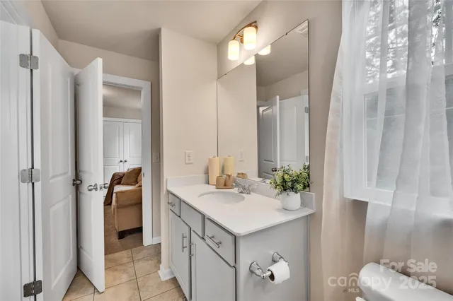 a bathroom with a sink vanity and a mirror