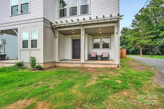 a view of a house with backyard porch and sitting area