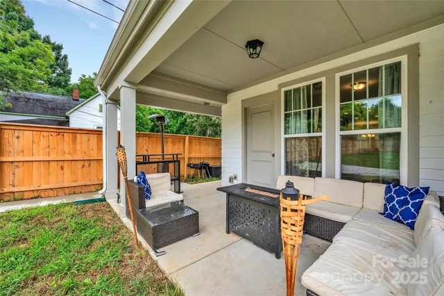 a building outdoor space with patio furniture and potted plants