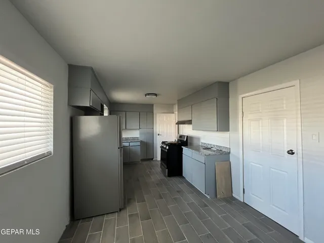 a kitchen with a refrigerator and a sink