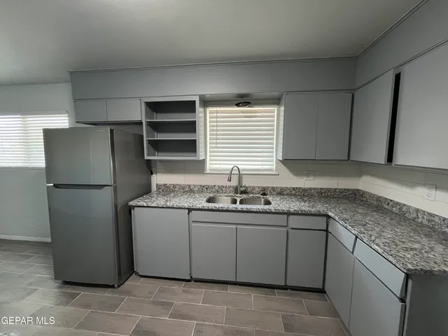 a kitchen with a sink and refrigerator