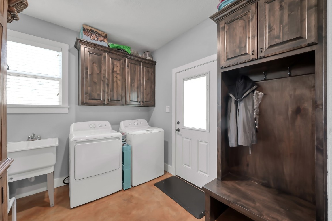 130 Cedar Court Magnolia, TX 77355 - Photo 9 of 26 Utility room with custom mud room rack and utility sink, also with an additional door leading to the back porch