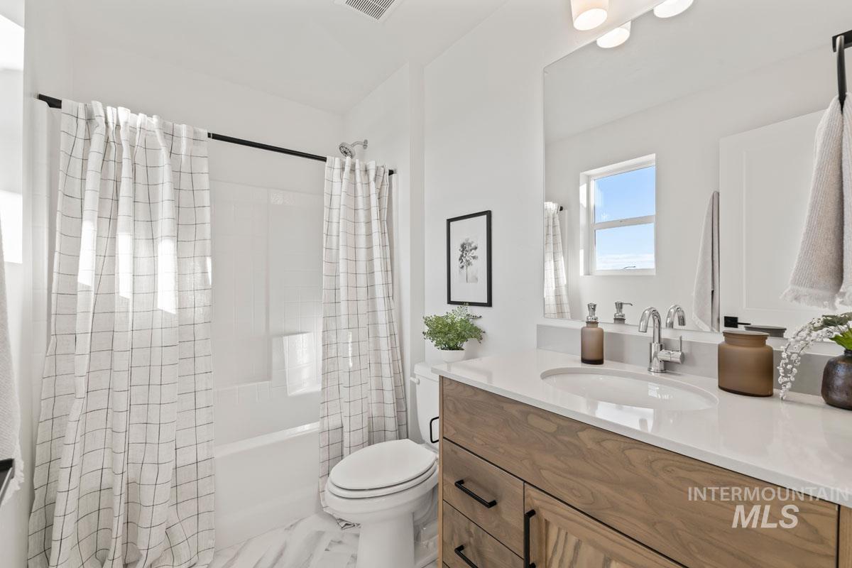 2113 East Deep Purple Lane Meridian, ID 83642 - Photo 8 of 11 Bathroom with vanity and shower / bath combo with shower curtain