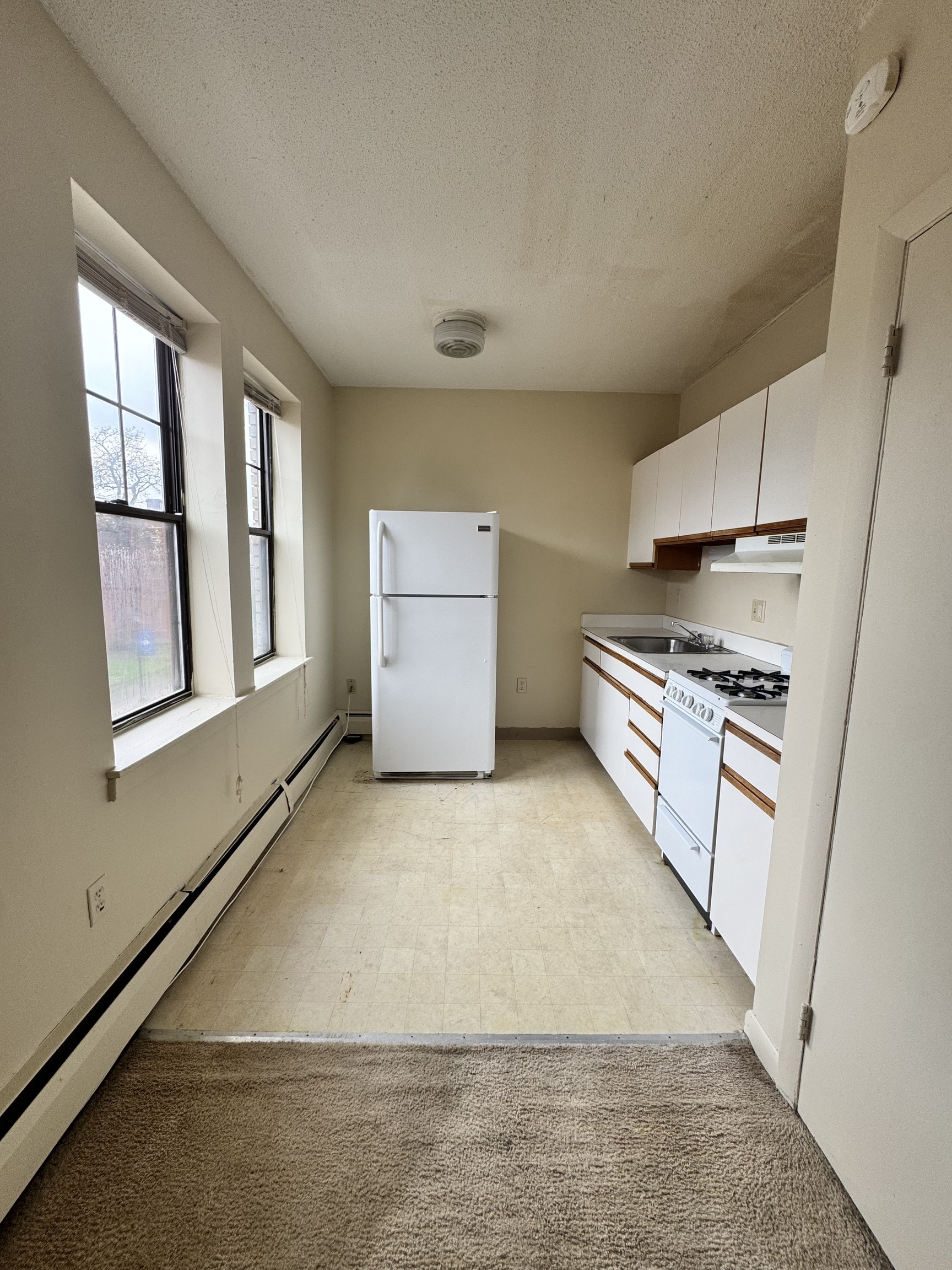 27 Congress Street, Unit 301 Hartford, CT 06114 - Photo 2 of 6 a kitchen with granite countertop a stove and a refrigerator