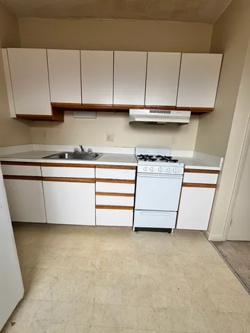 a view of kitchen with granite countertop cabinets