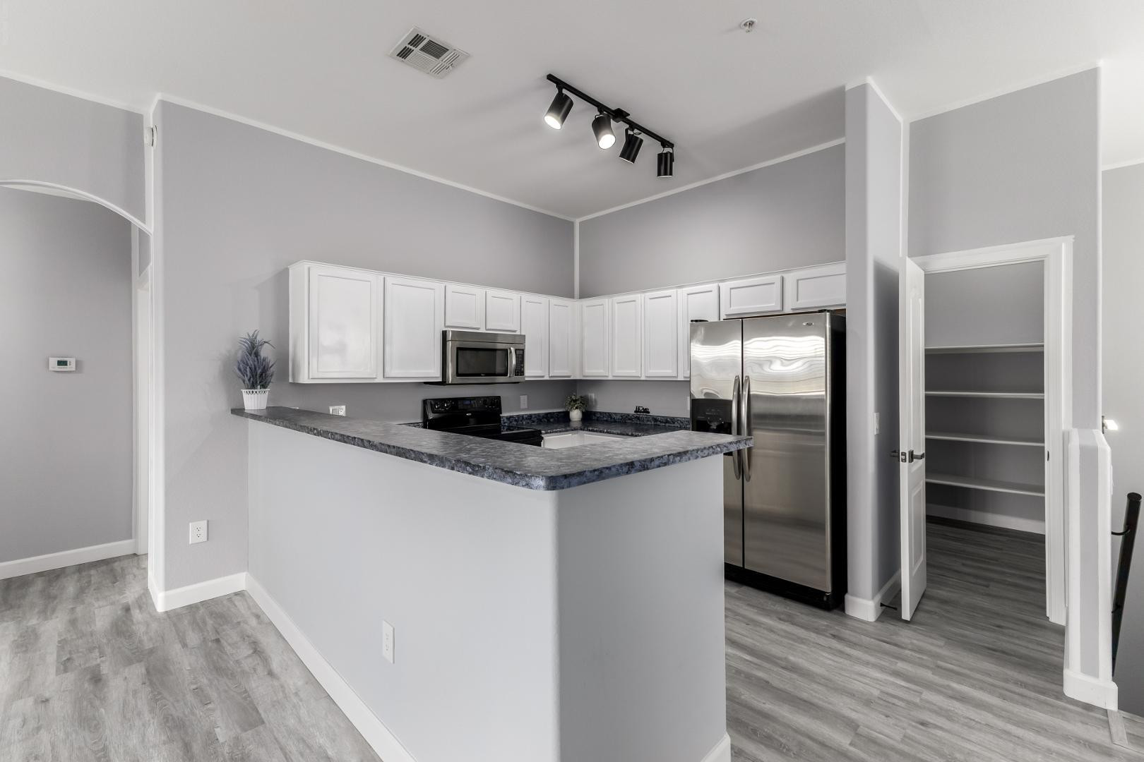 1350 South Greenfield Road, Unit 2205 Mesa, AZ 85206 - Photo 13 of 42 a kitchen with stainless steel appliances granite countertop a refrigerator and a stove top oven