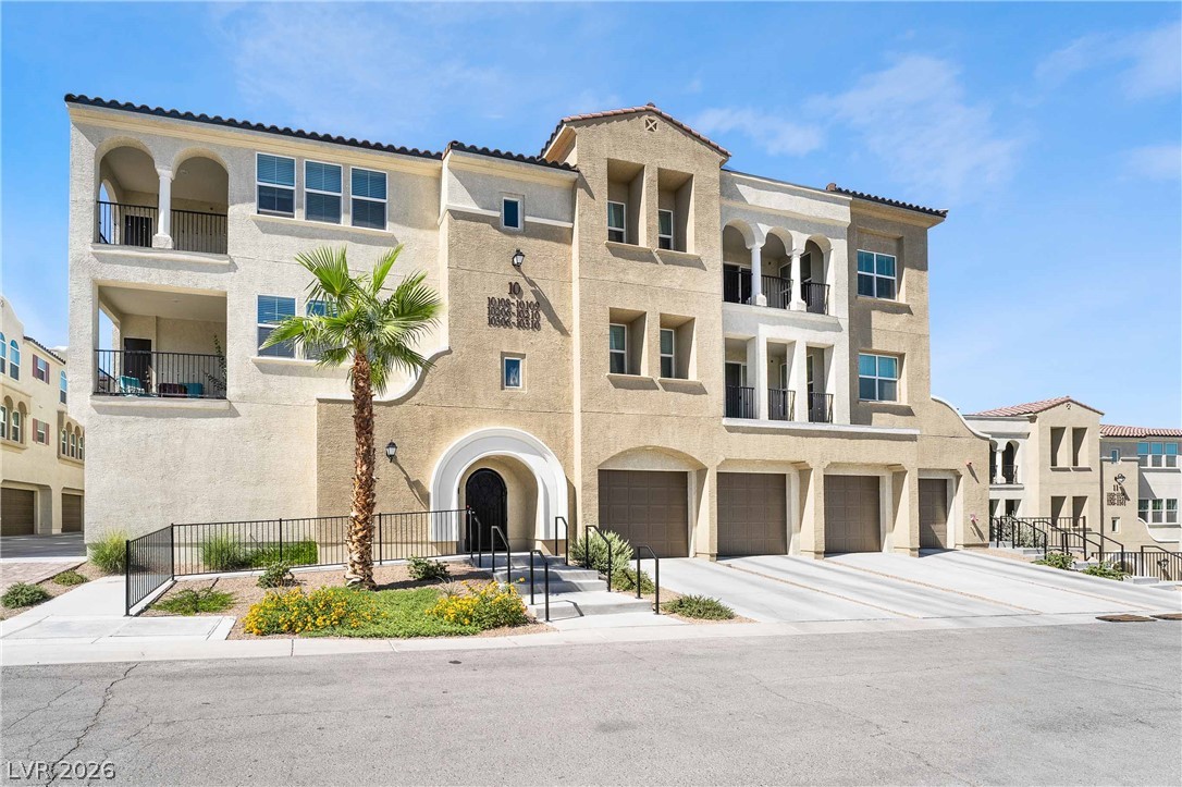 2555 Hampton Road, Unit 10202 Henderson, NV 89052 - Photo 3 of 35 Multi-level Mediterranean stucco exterior features arched entries, multiple balconies, and integrated garage parking.