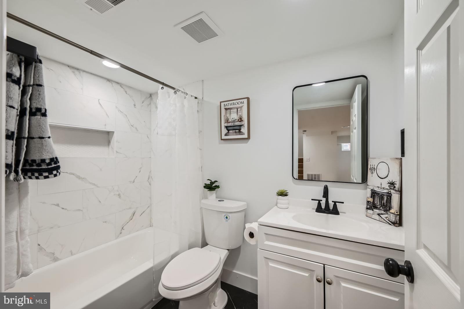 3814 Cedardale Road Baltimore, MD 21215 - Photo 26 of 28 a bathroom with a sink a toilet and a bathtub