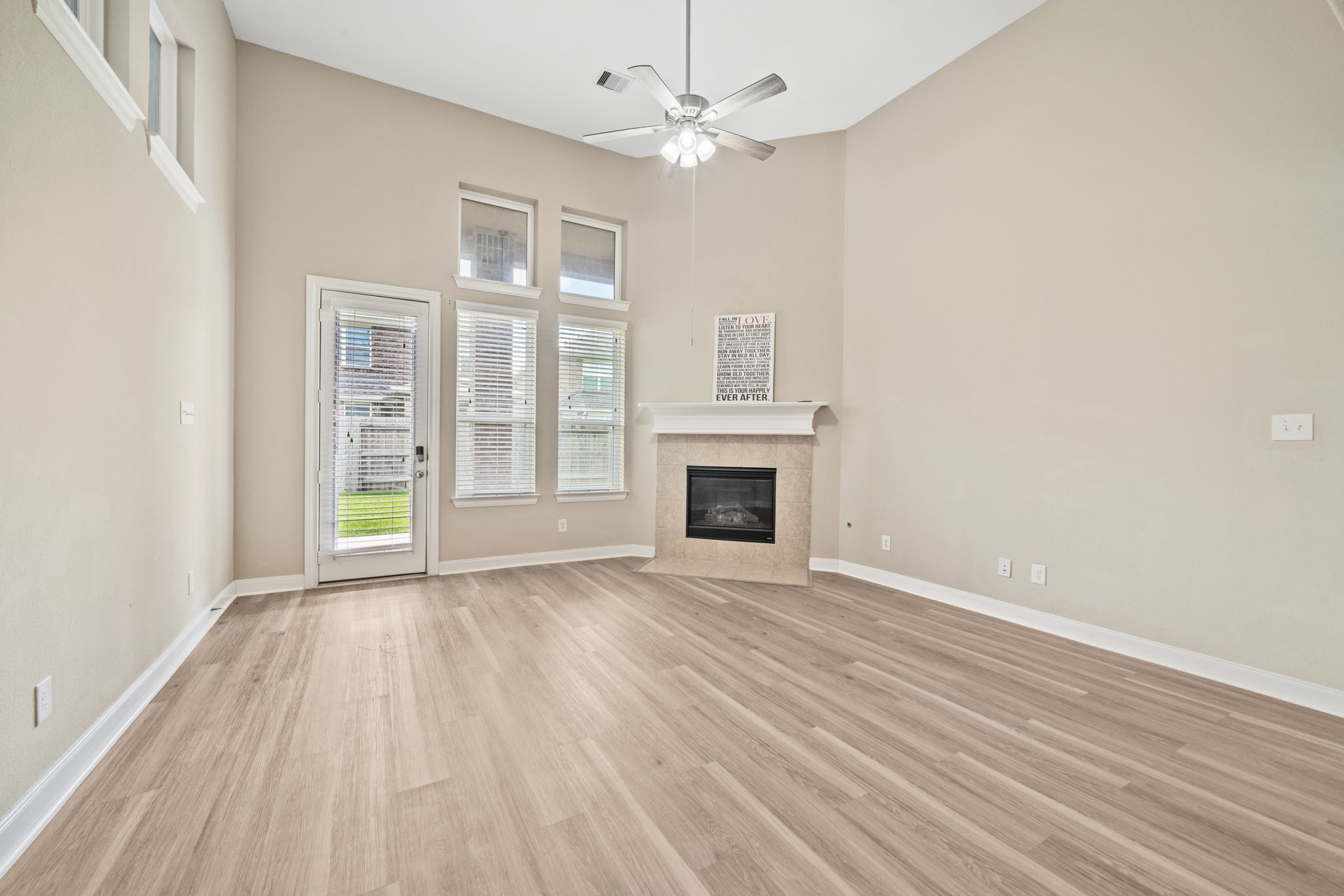 22523 Birch Ridge Meadow Drive Spring, TX 77389 - Photo 15 of 39 wooden floor fireplace and natural light in room