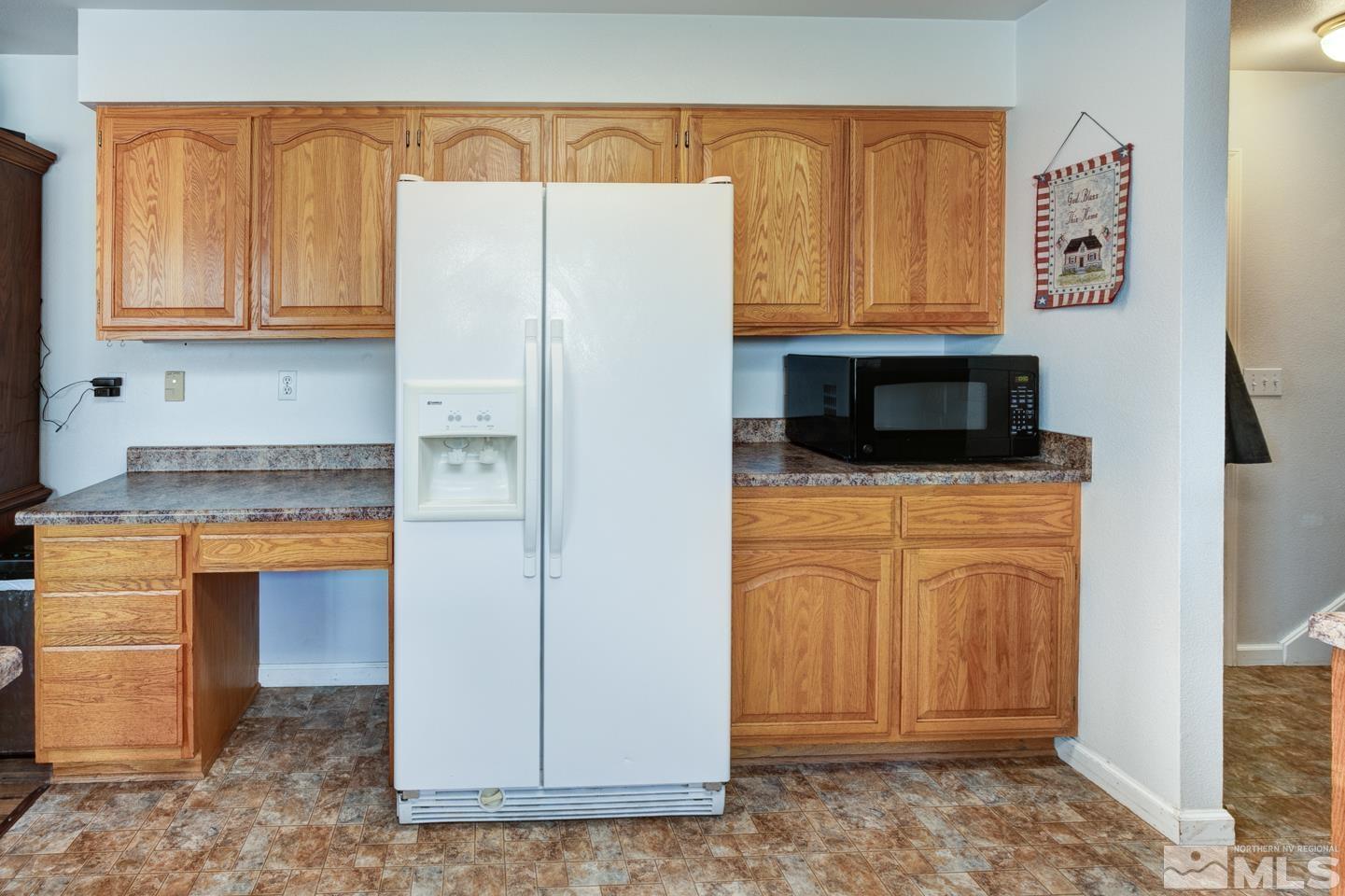 4170 Bottom Road Fallon, NV 89406 - Photo 12 of 38 a kitchen with stainless steel appliances granite countertop a refrigerator a stove and a sink