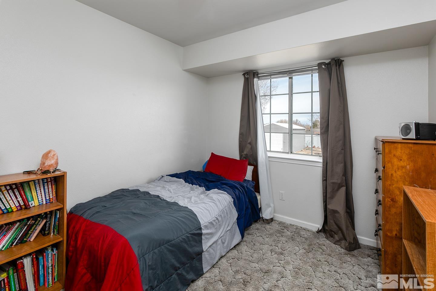 4170 Bottom Road Fallon, NV 89406 - Photo 18 of 38 a bedroom with a bed and a book shelf