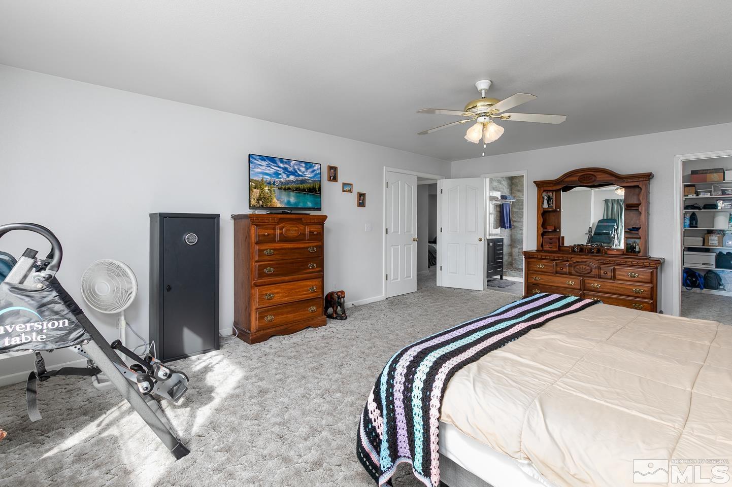 4170 Bottom Road Fallon, NV 89406 - Photo 23 of 38 a bedroom with a bed and a chandelier
