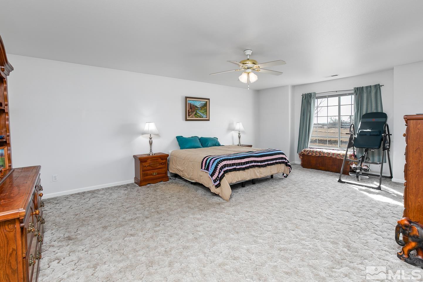 4170 Bottom Road Fallon, NV 89406 - Photo 24 of 38 a bedroom with a bed and a chandelier