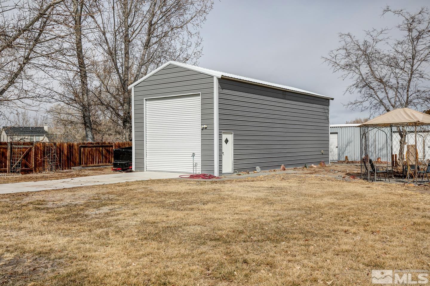 4170 Bottom Road Fallon, NV 89406 - Photo 36 of 38 a front view of a house with a yard and garage