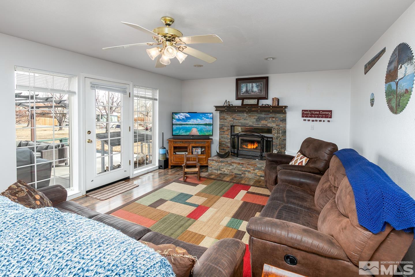 4170 Bottom Road Fallon, NV 89406 - Photo 6 of 38 a living room with furniture a fireplace and a flat screen tv