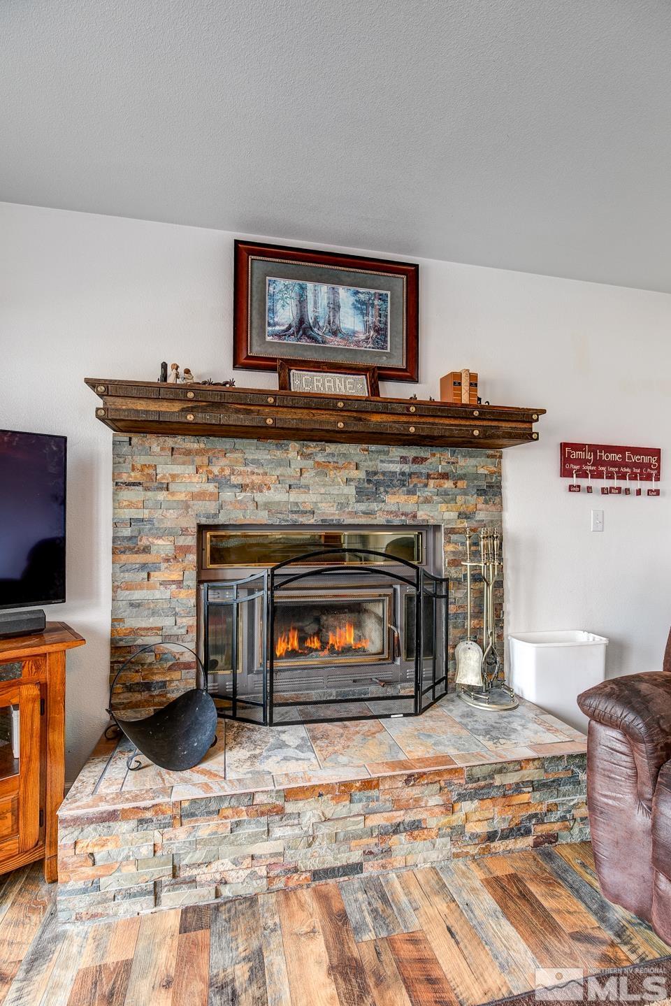 4170 Bottom Road Fallon, NV 89406 - Photo 7 of 38 a living room with furniture a fireplace and a flat screen tv