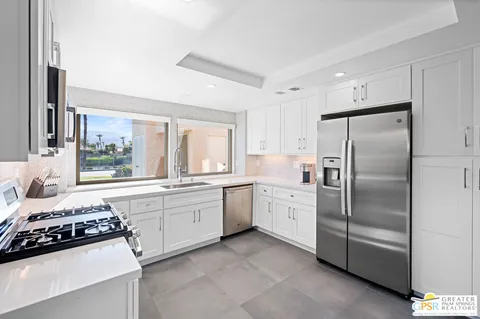 a kitchen with a stove a sink and a refrigerator