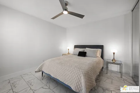 a bedroom with a bed and a lamp