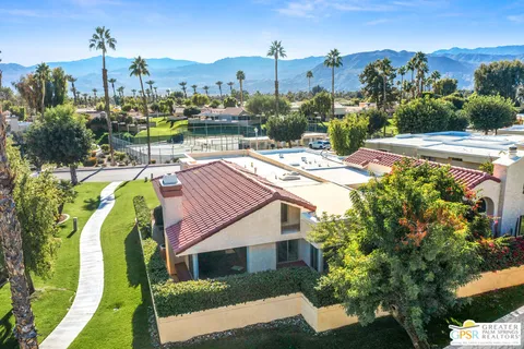 a view of a house with a yard and sitting area
