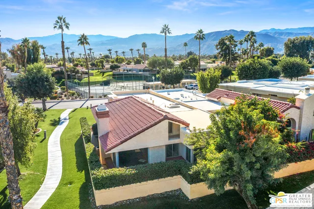 a view of a house with a yard and sitting area