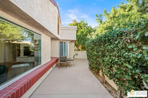 a balcony with furniture and a potted plant