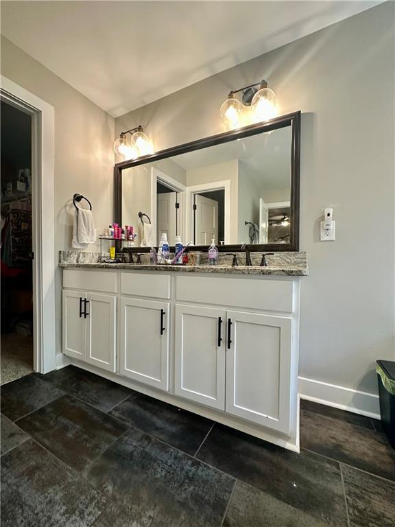 815 Poplar Street Monticello, GA 31064 - Photo 25 of 33 a bathroom with a sink vanity and mirror